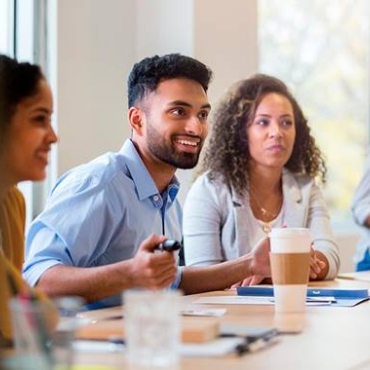 Employees sitting around conference table